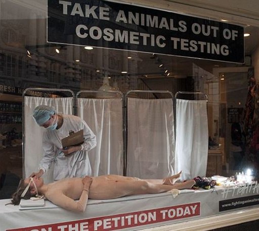 woman in a nude body suit on display in a London Shop window