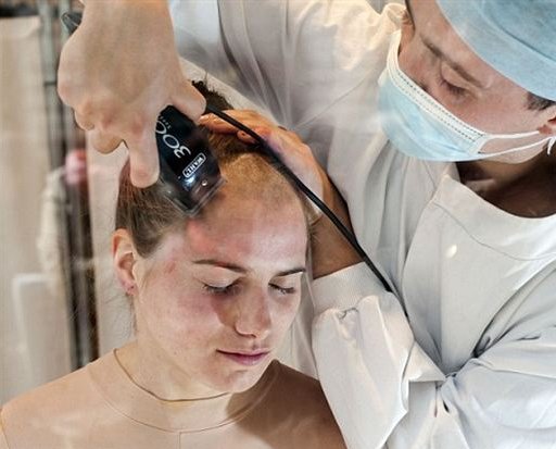 woman\'s head is publicly shaved as part of a protest against animal testing