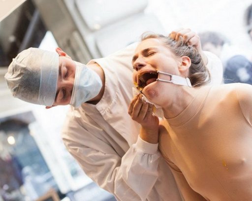 gaggged woman being force fed in a London shop window, to her evident distress