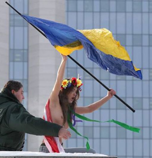 waving the flag at Gazprom in moscow -- topless