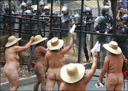 naked women face off with riot police during protest
