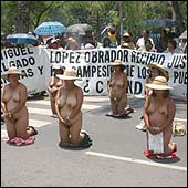 nude women kneeling during a protest