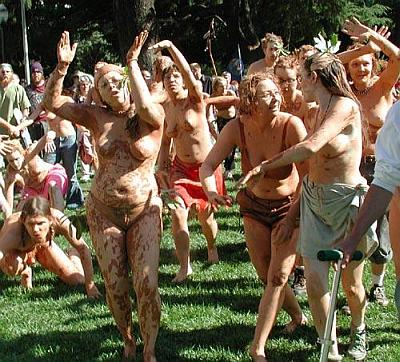 naked protesters wallowing in mud like pigs