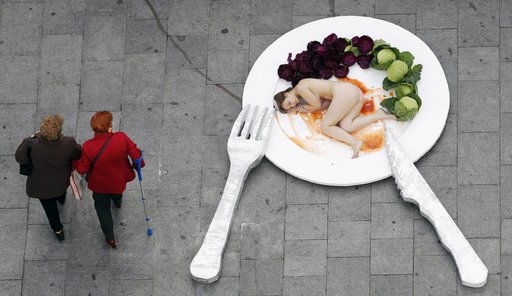 nude in the street on a plate of oversized food