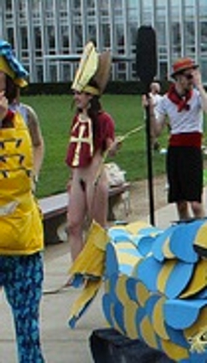 naked protester with pubic hair shaved like a cross and wearing a pope hat