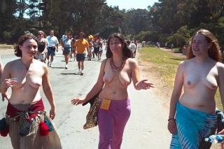 hippie girls stripped to the waist and marching half-nude in merriment