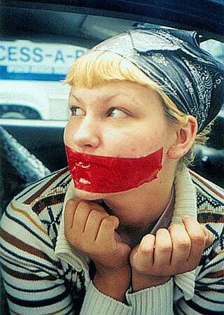 tape gagged woman protesting in public